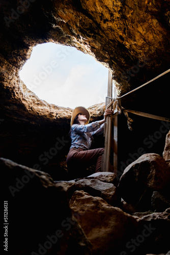 Hiker exploring a cave on vacation