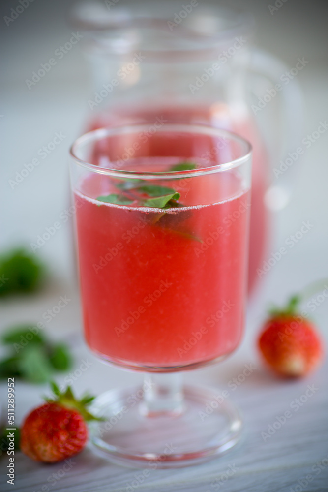 Cold summer strawberry kvass with mint in a glass Cold summer strawberry kvass with mint in a glass