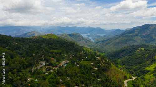 Top view of Mountain slopes with rainforest and a mountain valley with farmland. Sri Lanka.