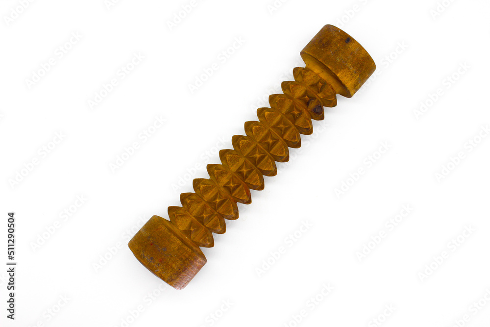 A picture of wooden massage roller on white background with selective focus A picture of wooden massage roller on white background with selective focus