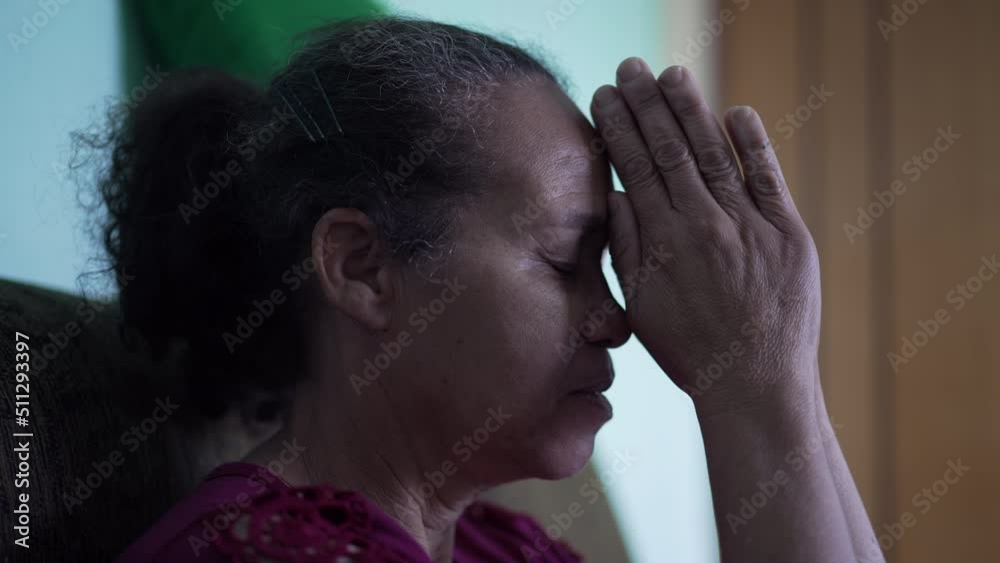 Spiritual senior woman praying to God. Contemplative older person