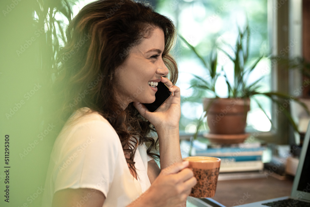 Beautifull young woman talking on phone and drinking coffe Beautifull young woman talking on phone and drinking coffe