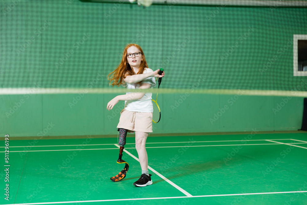 Girl with artificial leg playing badminton Girl with artificial leg playing badminton