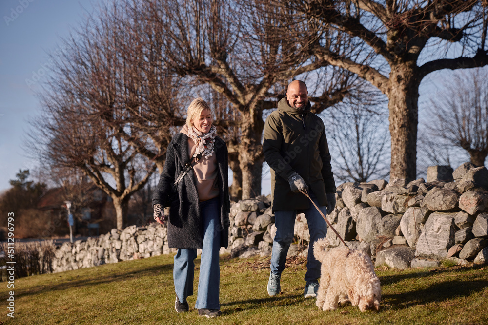 Couple walking with dog Couple walking with dog