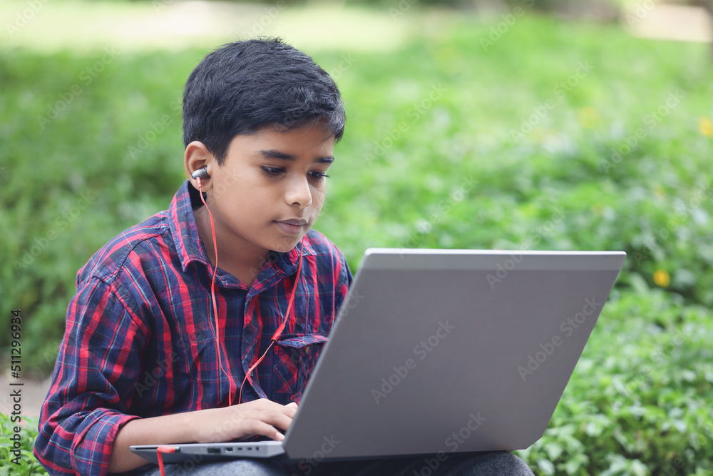 Portrait of Indian boy using laptop while attending the online classes
Portrait of Indian boy using laptop while attending the online classes