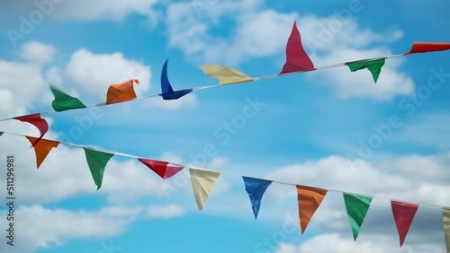 Flags fluttering on wind against blue sky
