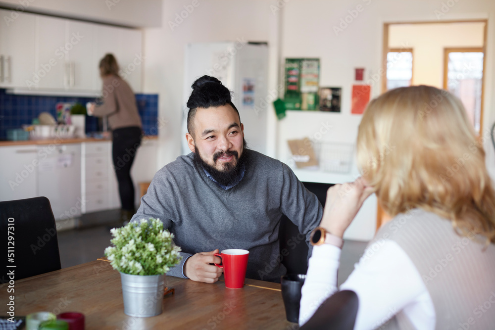Co-workers talking during coffee break Co-workers talking during coffee break