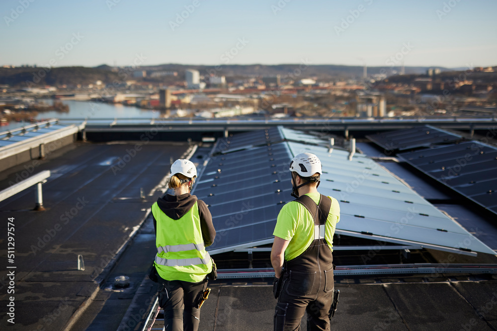 Workers standing on roof Workers standing on roof