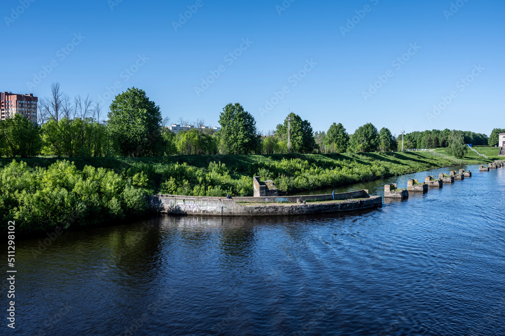 river boat passes through the lock on the river on a summer day