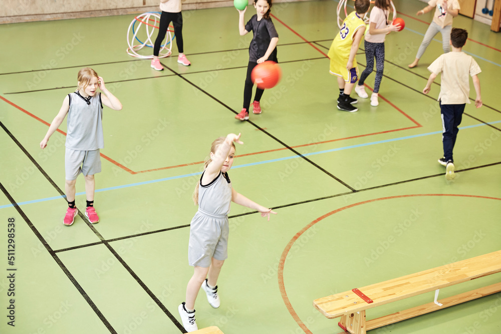 Children having PE class in school gym Children having PE class in school gym