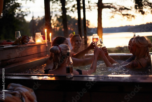 Female friends relaxing in hot tub photo