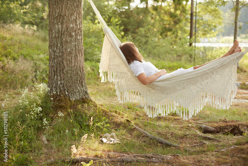 Woman relaxing in hammock photo