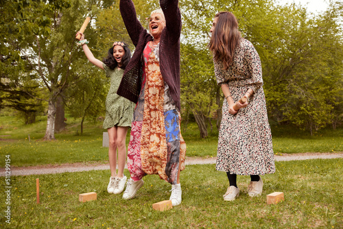 People playing molkky outdoors and cheering photo