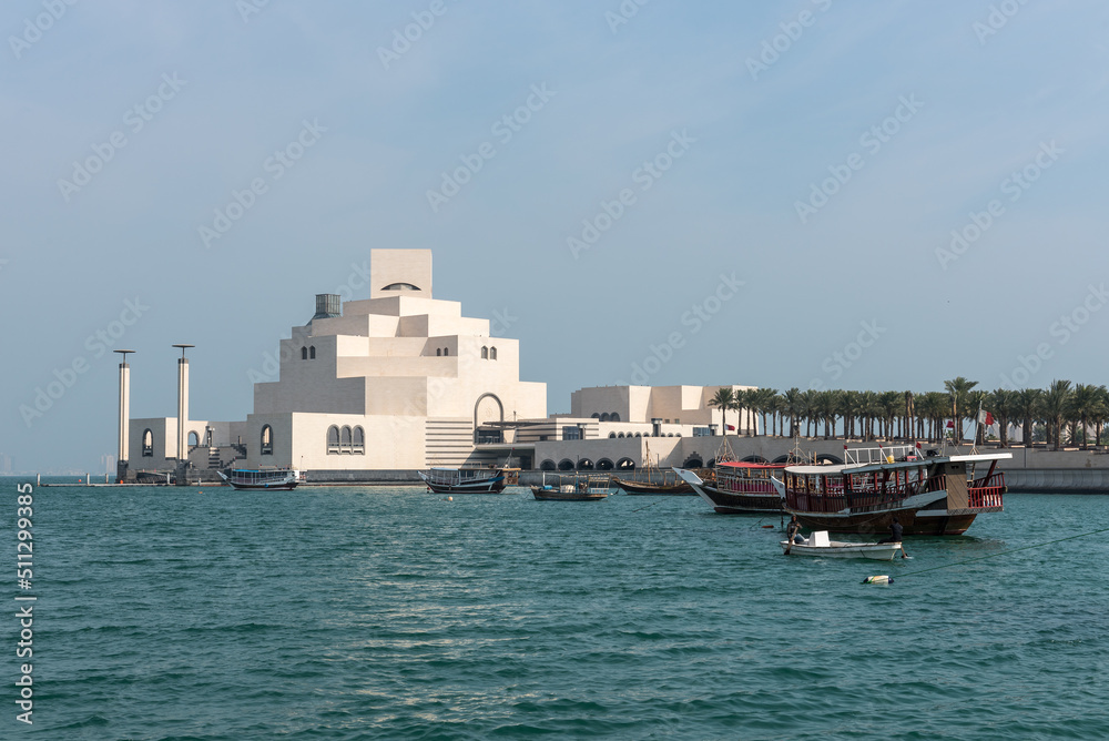 Traditional Qatari dhow on a background of a modern city of West Bay Doha, Qatar.