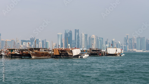 Traditional Qatari dhow on a background of a modern city of West Bay Doha, Qatar.