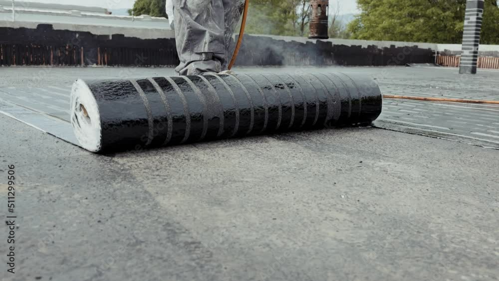Industrial flat roofing waterproofing system, installed by professionals with a fire burner