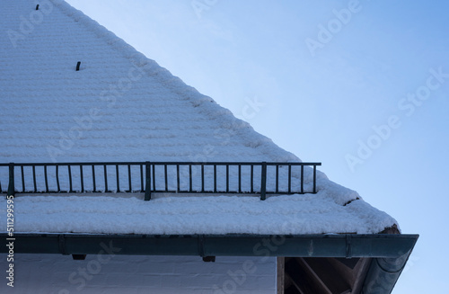 a roof in winter with a snow fence
