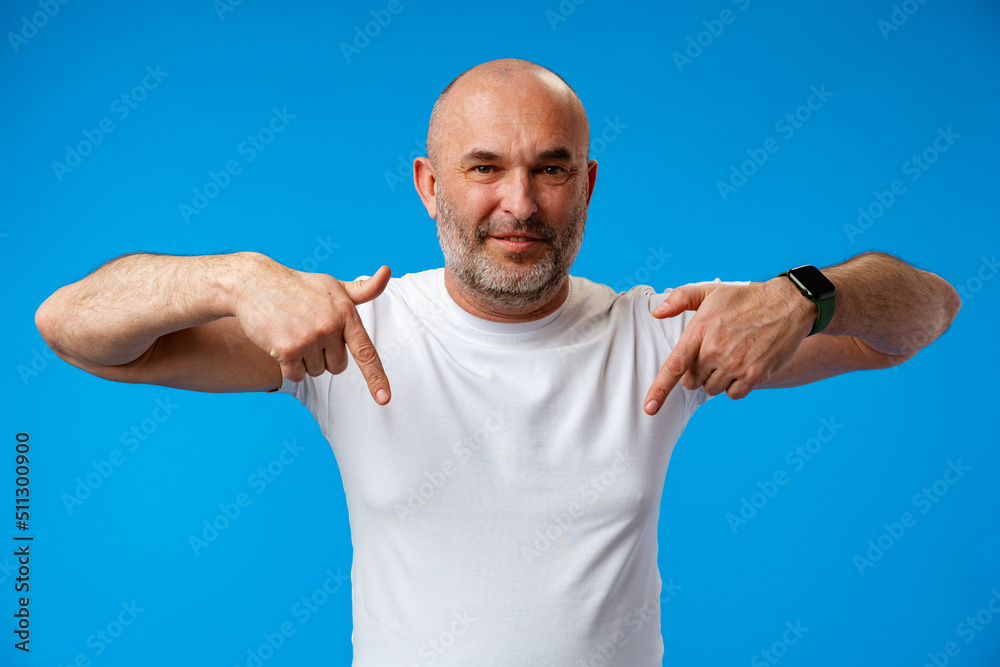Fototapeta premium Handsome middle age mature man pointing to copy space