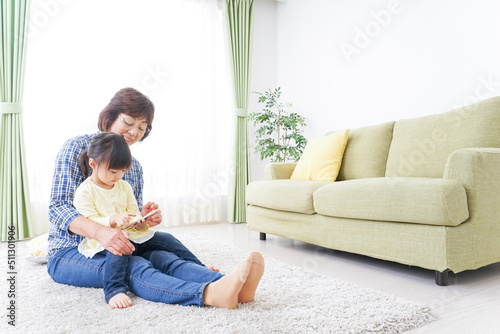 Child using smartphone with grandmother