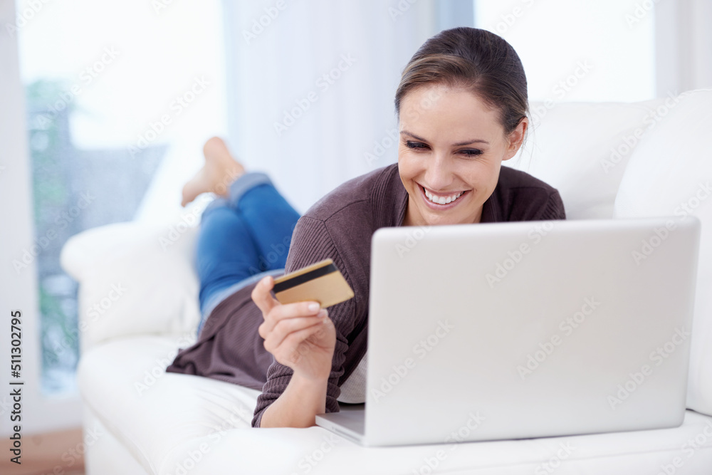 Shopping from my sofa. A young woman doing online shopping. Shopping from my sofa. A young woman doing online shopping.