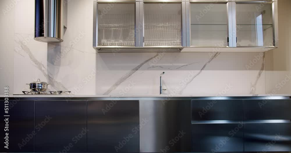 Modern Minimalist Home. Modern gray and white kitchen room furniture. Elegant and Comfortable Home at Dining room. Domestic Kitchen with modern sink. Modern Kitchen room with minimalist dining table. Modern Minimalist Home. Modern gray and white kitchen room furniture. Elegant and Comfortable Home at Dining room. Domestic Kitchen with modern sink. Modern Kitchen room with minimalist dining table.