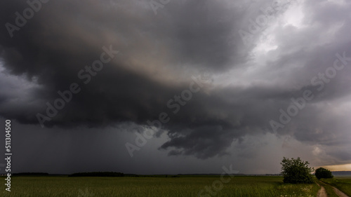 Storm clouds over field, tornadic supercell, extreme weather, dangerous storm