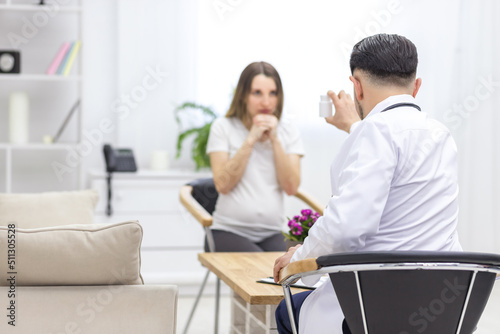 Photo of pregnant woman visiting her doctor.