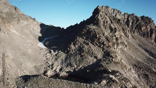 Mountain rocky summit in the alps, Switzerland. blue sky, snow, drone aerial view photo