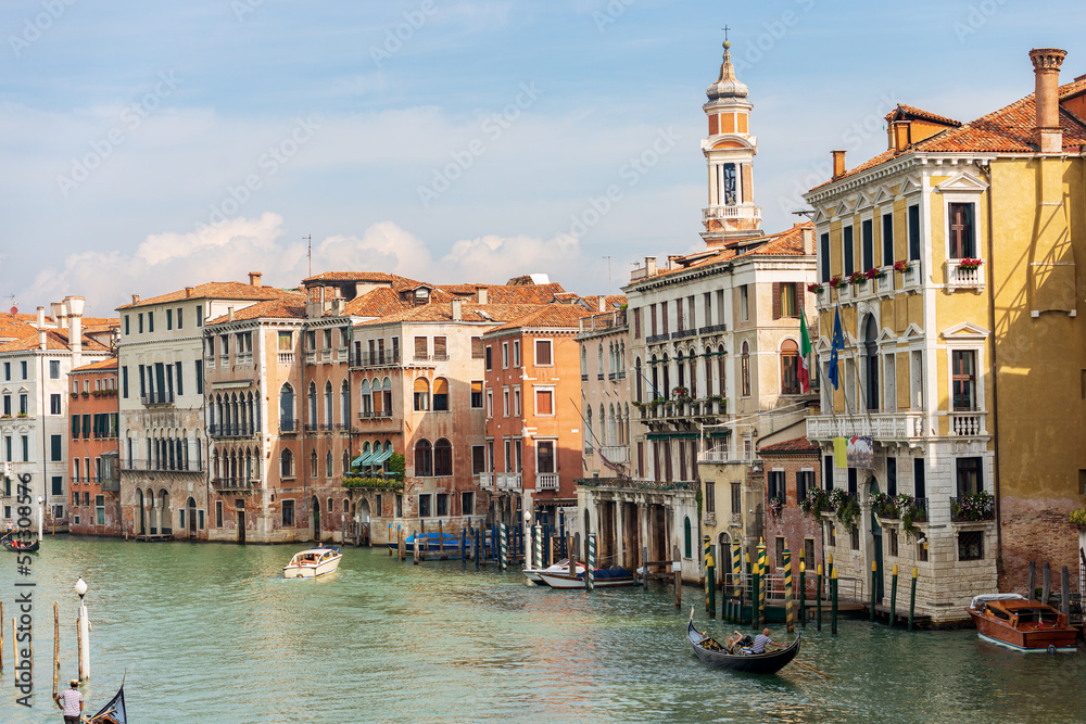 Venice. Canal Grande (Grand Canal) view from the Ponte di Rialto, the oldest and most famous bridge in the lagoon, UNESCO world heritage site, Veneto, Italy. Bell tower of Church of Santi Apostoli.