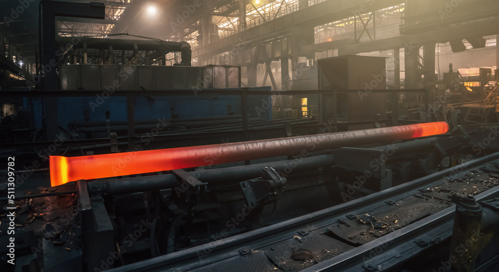 Freshly cast hot cast iron pipes at smelter. Manufacture of pipes for water, gas or oil. Freshly cast hot cast iron pipes at smelter. Manufacture of pipes for water, gas or oil.