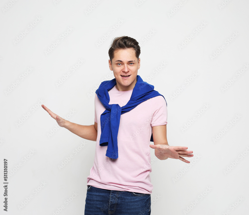 lifestyle, emotion and people concept: Shocked amazed surprised man standing keeping mouth open spreading hands lifestyle, emotion and people concept: Shocked amazed surprised man standing keeping mouth open spreading hands