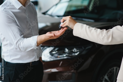 man in a car dealership buys a car