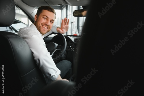 Fotomurale Portrait of a handsome male chauffeur sitting in a car