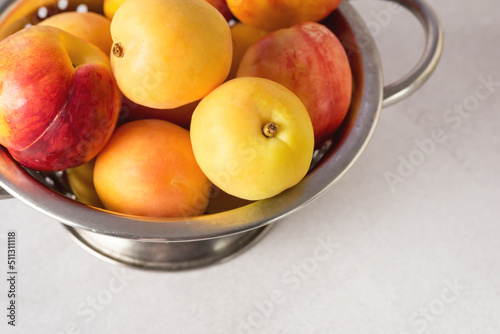 Group of Delicious Freshly Washed Peaches Dripping in a Colander Above Horizontal