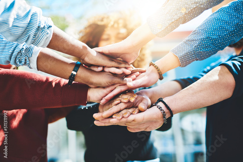 One for all. Cropped shot of an unrecognizable group of college friends standing outside with their hands in a huddle.