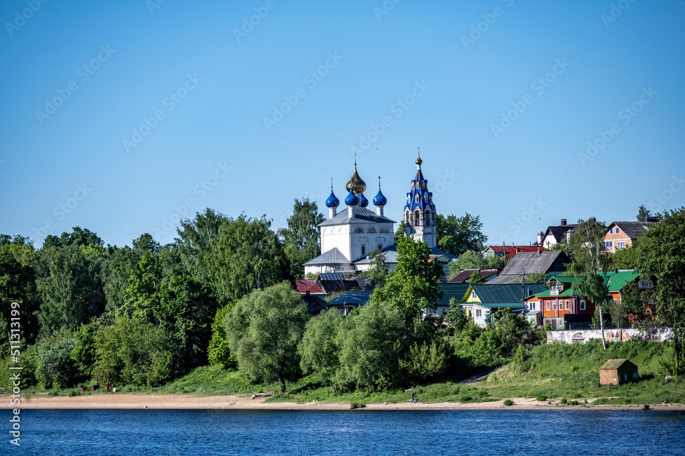 summer landscape with ancient churches against the backdrop of a forest and a river on a sunny day summer landscape with ancient churches against the backdrop of a forest and a river on a sunny day