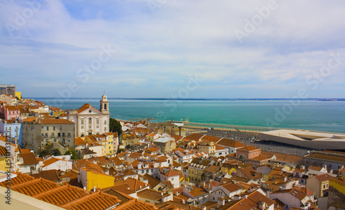 View of Alfama district from Santa Luzia viewpoint (miradouro) with Sao Vicente de Fora Church in the background in Lisbon, Portugal	