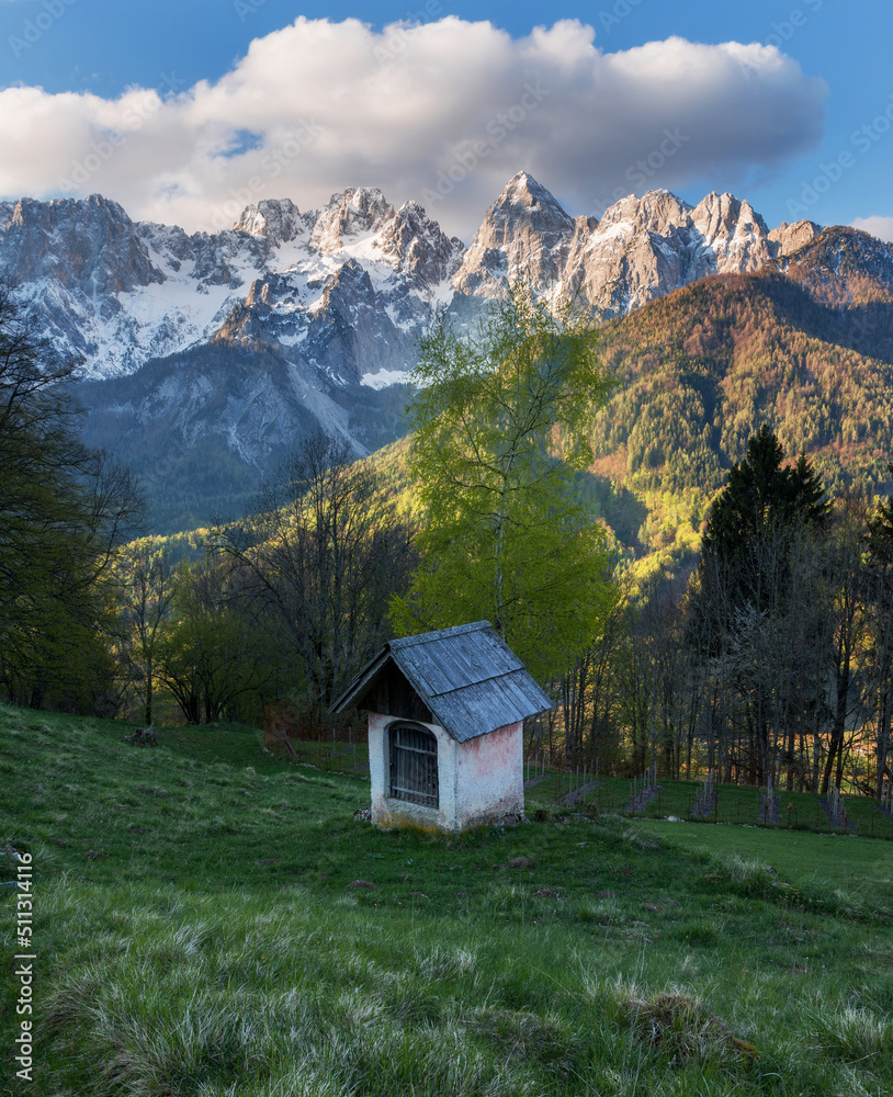 Sunrise in the mountains and hills in the spring with cottage and trees.