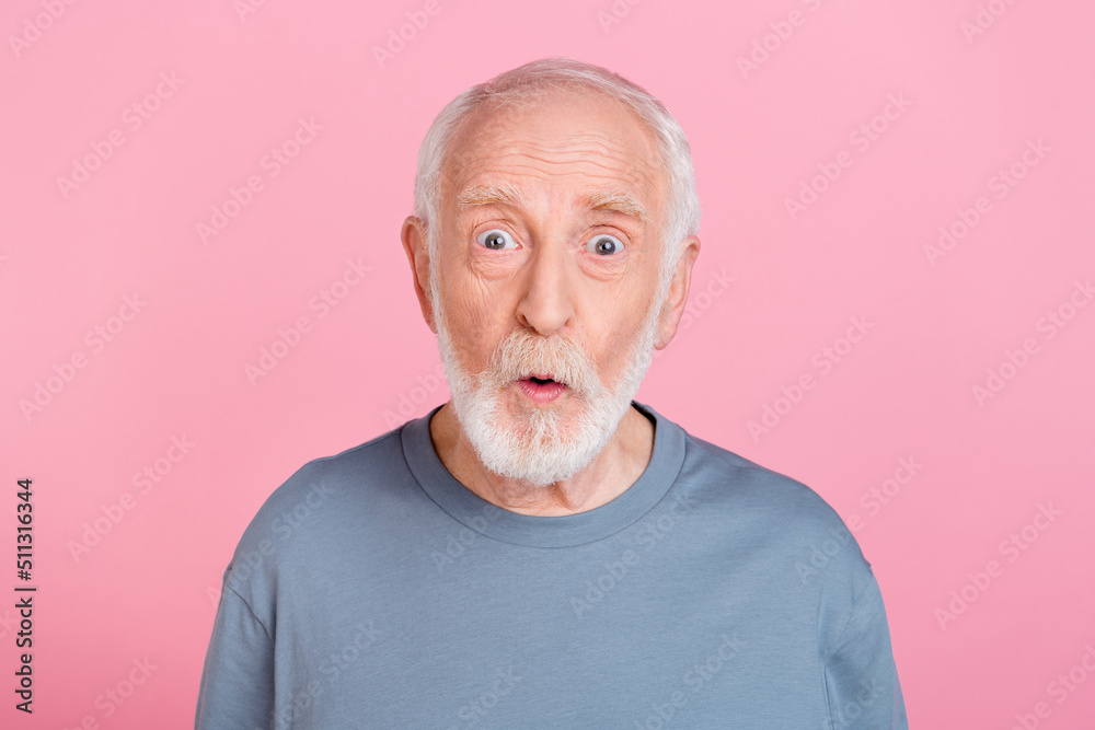 Photo of excited aged grey hairdo man look camera wear blue shirt isolated on pink color background Photo of excited aged grey hairdo man look camera wear blue shirt isolated on pink color background