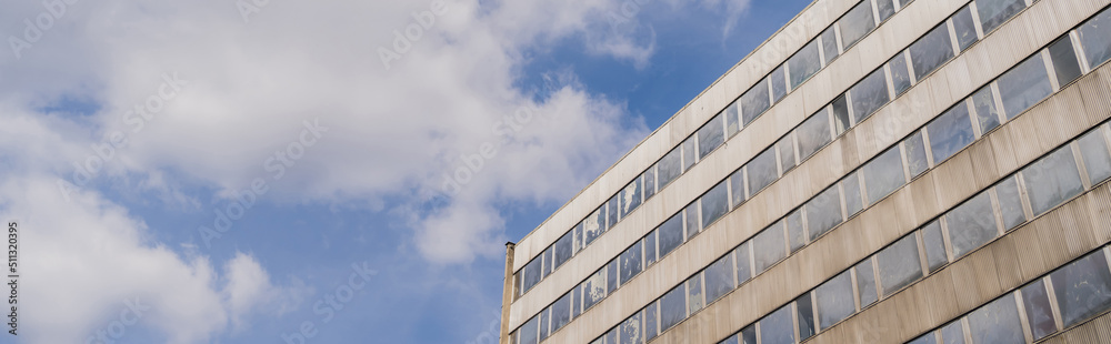 Low angle view of building and cloudy sky in Wroclaw, banner