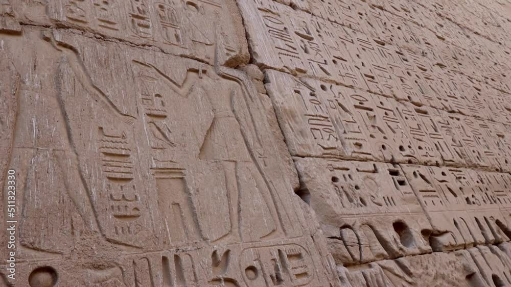 Ancient drawings on the walls of the Medinet Habu Temple in Luxor, Egypt Ancient drawings on the walls of the Medinet Habu Temple in Luxor, Egypt