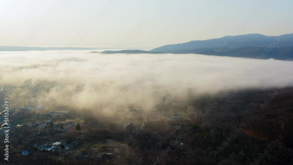 Flight over the valley covered with morning mist in the countryside. High hills river beautiful morning sunrise natural landscape. Drone view Flight over the valley covered with morning mist in the countryside. High hills river beautiful morning sunrise natural landscape. Drone view