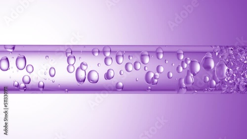 Macro shot of different sized clear bubbles flowing in glass tube with clear liquid on purple background | Abstract body care cosmetics mixing concept photo