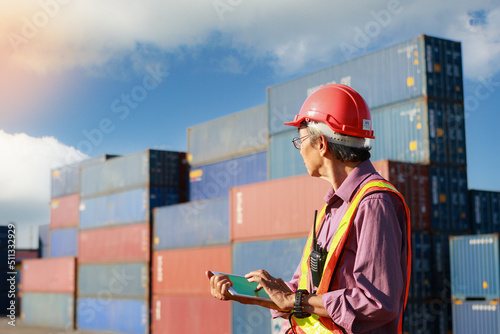 senior supervisor A man uses a tablet to control and inspect products