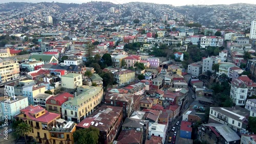 Aerial parallax of charming colorful houses and cars driving in Urriola street, Cerro Concepcion and Valparaiso hillside, Chile photo