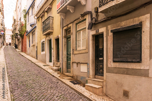 Fototapeta Naklejka Na Ścianę i Meble -  Old street in Lisbon with interesting doors and windows
