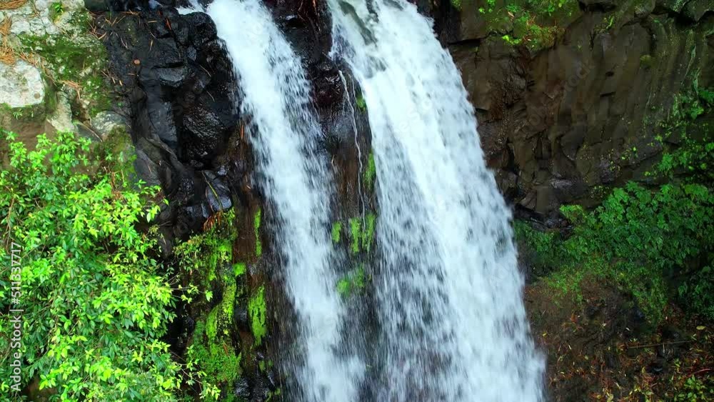 The image accompanying the falling water at Rio do Ouro waterfall at roca Agostinho Neto,Sao Tome,Africa.