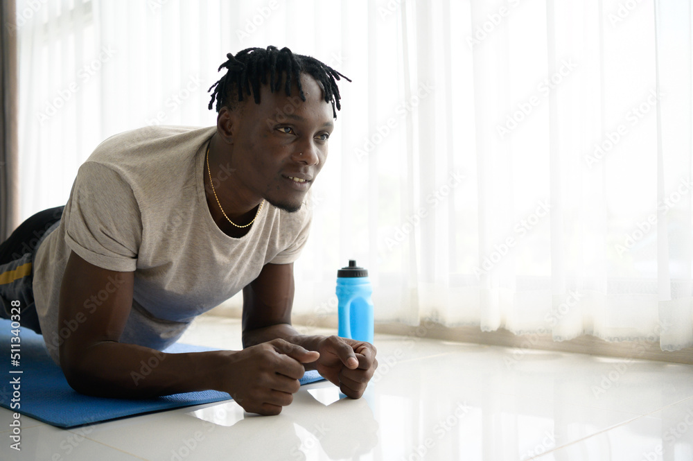 Young African man doing yoga exercise in the living room of his homewith the pleasure of relaxing with light sports In the morning atmosphere of the day. Young African man doing yoga exercise in the living room of his homewith the pleasure of relaxing with light sports In the morning atmosphere of the day.