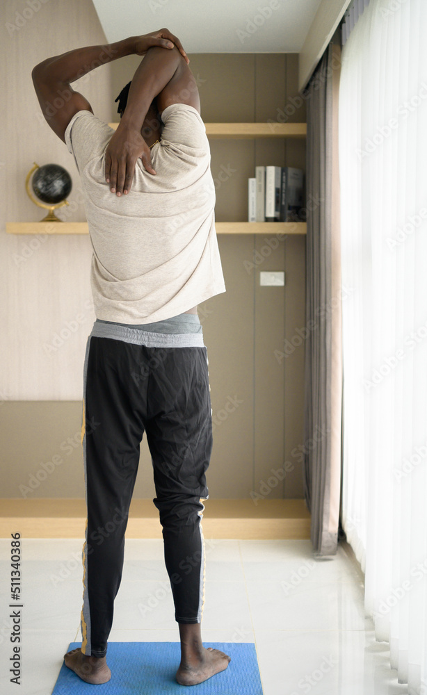 Young African man doing yoga exercise in the living room of his homewith the pleasure of relaxing with light sports In the morning atmosphere of the day. Young African man doing yoga exercise in the living room of his homewith the pleasure of relaxing with light sports In the morning atmosphere of the day.