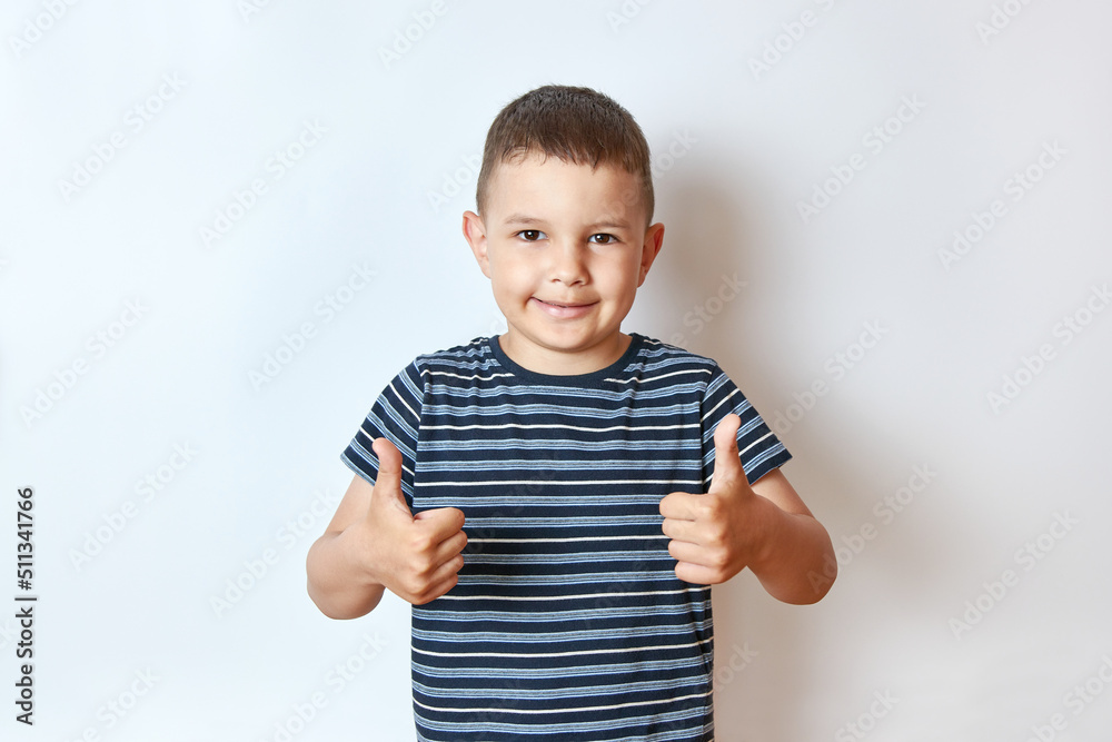 A handsome smiling boy shows his hands to his liking. A handsome smiling boy shows his hands to his liking.